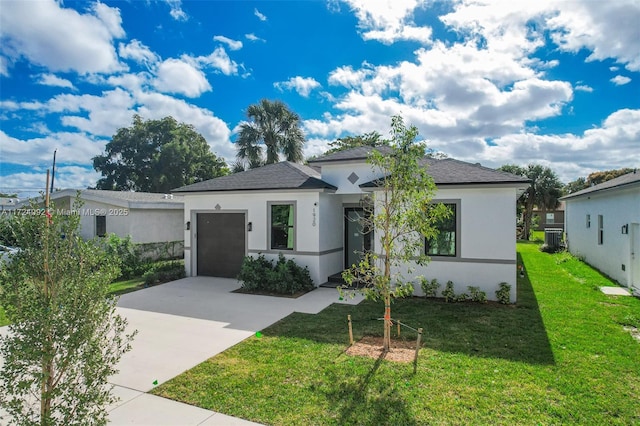 view of front of property featuring a front yard, a garage, and cooling unit