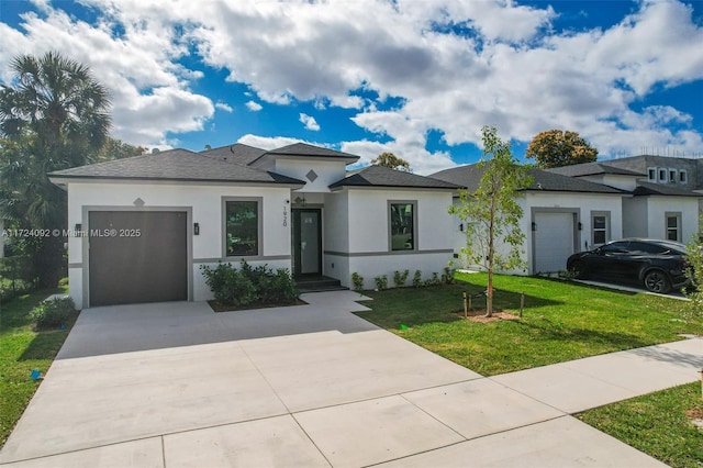 prairie-style house featuring a garage and a front yard