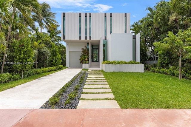 view of front of home with a front yard and a garage