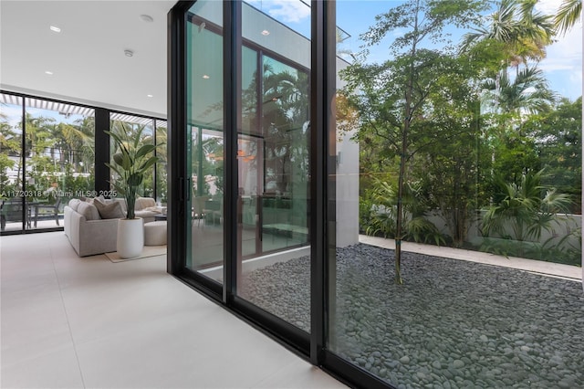 entryway with tile patterned flooring, a wealth of natural light, and floor to ceiling windows