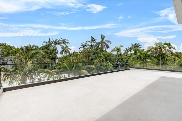 view of patio with a water view and a balcony