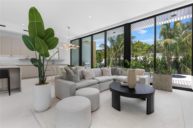 living room with ceiling fan and floor to ceiling windows