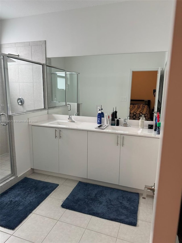 bathroom featuring tile patterned flooring, vanity, and a shower with shower door