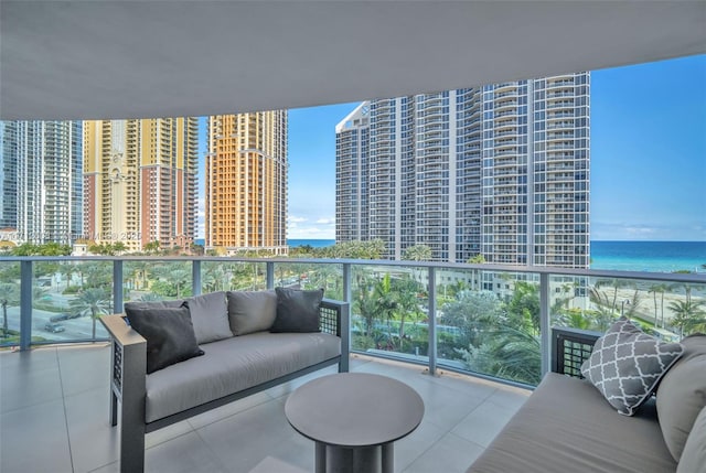 balcony featuring an outdoor living space and a water view