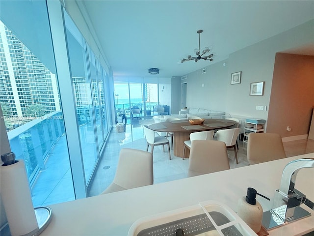 dining space featuring ceiling fan and a wall of windows