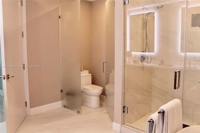 bathroom featuring toilet and an enclosed shower