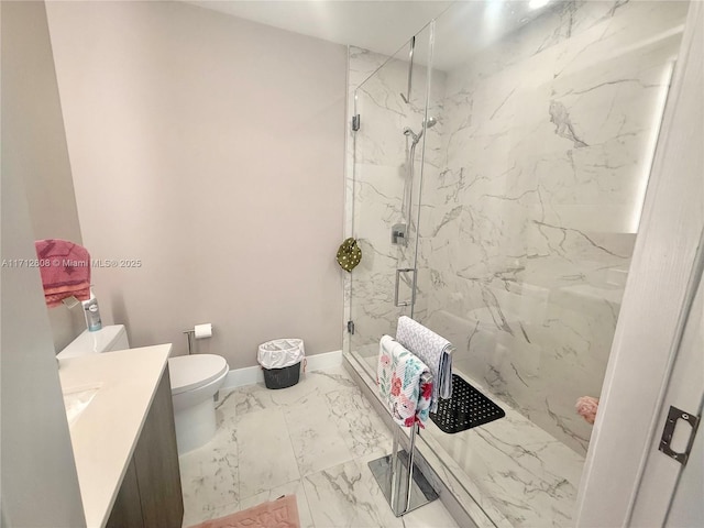 bathroom featuring toilet, vanity, and a shower with shower door