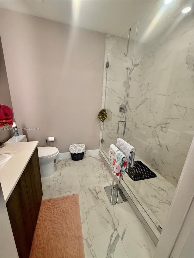 bathroom featuring toilet, vanity, and an enclosed shower