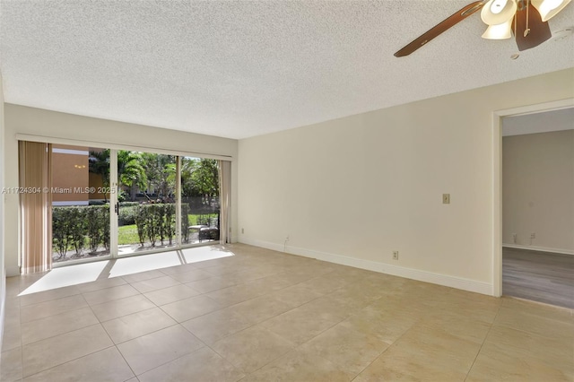 tiled empty room featuring a textured ceiling and ceiling fan