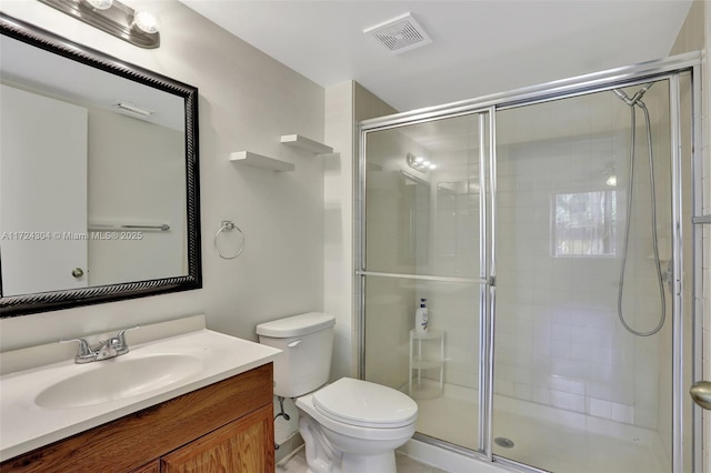 bathroom with vanity, an enclosed shower, and toilet