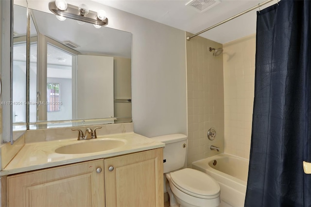 full bathroom featuring vanity, shower / bath combination with curtain, and toilet