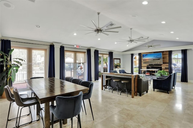 dining space with ceiling fan and vaulted ceiling