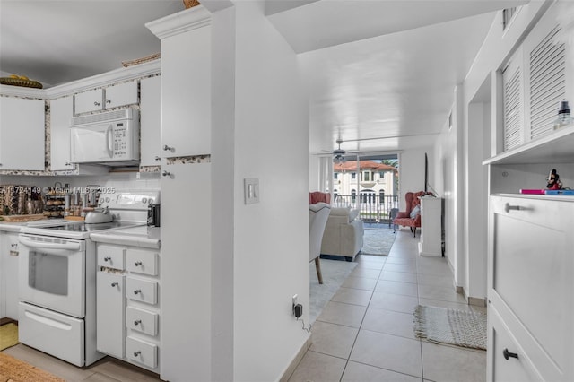 kitchen featuring backsplash, white appliances, ceiling fan, light tile patterned floors, and white cabinets