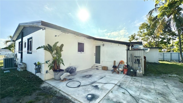 back of house featuring central AC and a patio area