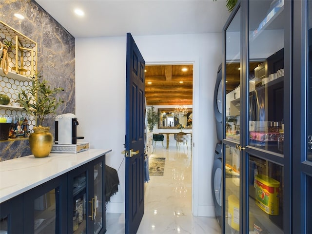 interior space with stacked washer and clothes dryer