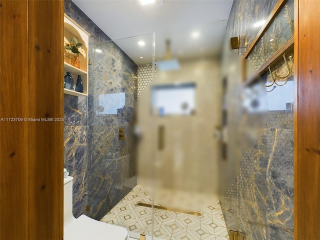 bathroom featuring tile walls and a shower