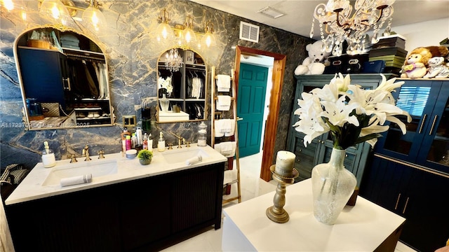 bathroom with a chandelier and vanity