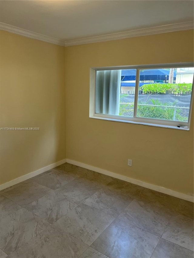 empty room featuring crown molding