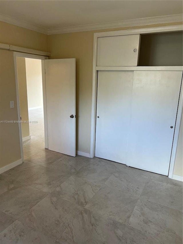 unfurnished bedroom featuring a closet and ornamental molding