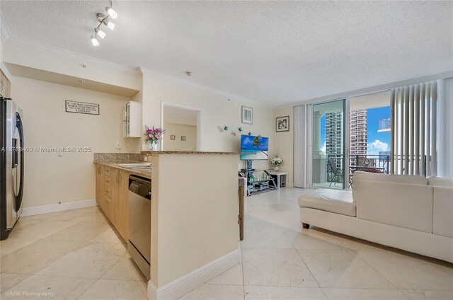 kitchen featuring sink, ornamental molding, a textured ceiling, and appliances with stainless steel finishes