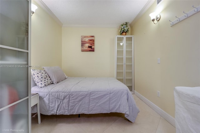 tiled bedroom with ornamental molding and a textured ceiling