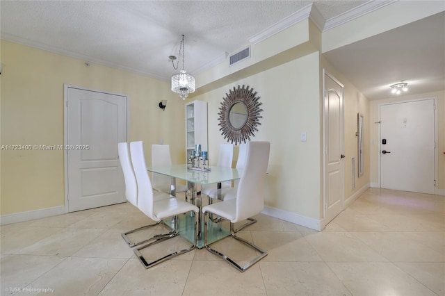 tiled dining space with ornamental molding and a textured ceiling