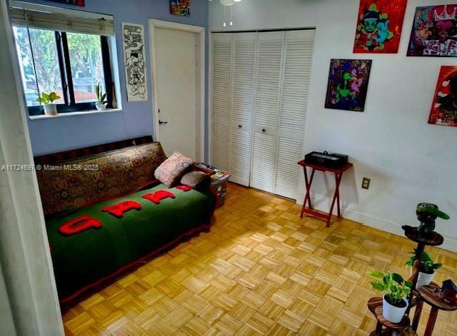 bedroom featuring a closet and light parquet flooring