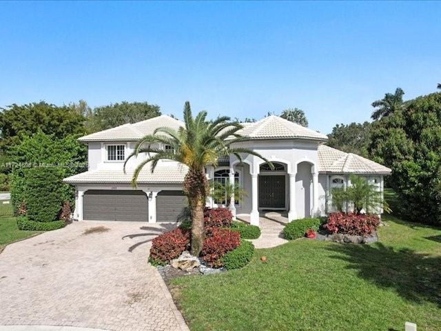 mediterranean / spanish home featuring a front yard