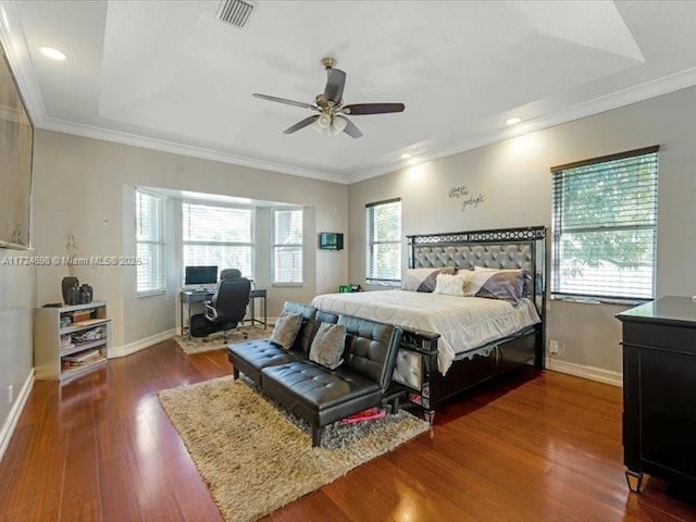 bedroom featuring dark wood-type flooring, ceiling fan, and ornamental molding