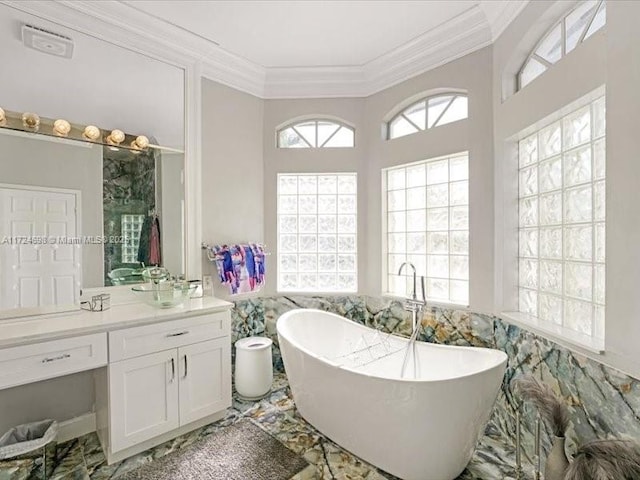 bathroom with a bathing tub, crown molding, and vanity