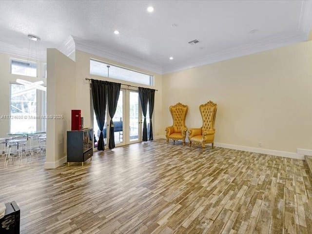 living area featuring crown molding and wood-type flooring