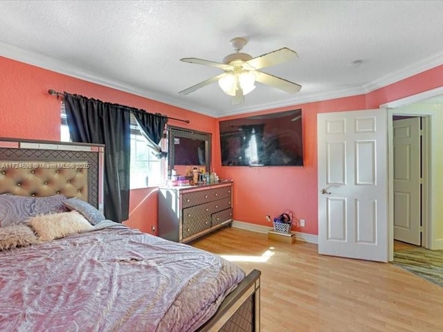 bedroom featuring ceiling fan, light hardwood / wood-style floors, and ornamental molding