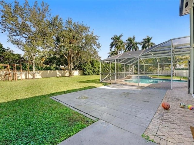 view of yard featuring a patio area, a lanai, a fenced in pool, and a playground