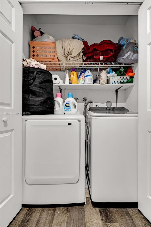 laundry room with washing machine and dryer and dark hardwood / wood-style floors