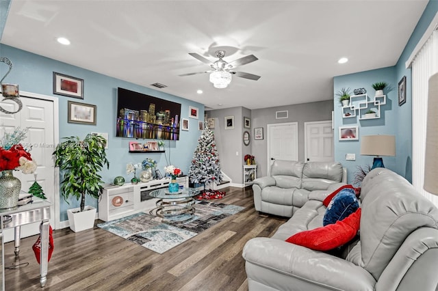 living room featuring ceiling fan and hardwood / wood-style flooring