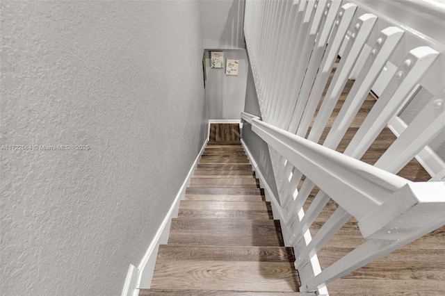 staircase featuring hardwood / wood-style flooring