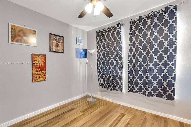 spare room with ceiling fan and hardwood / wood-style flooring