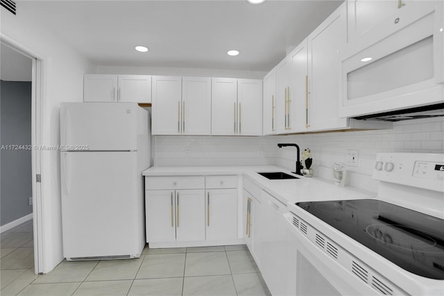 kitchen featuring light tile patterned floors, sink, white appliances, and white cabinetry