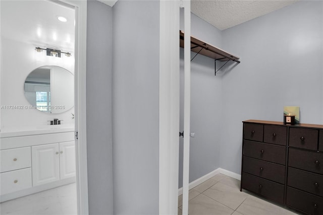 walk in closet featuring light tile patterned floors