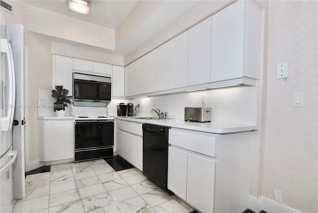 kitchen featuring sink, white cabinets, and black appliances