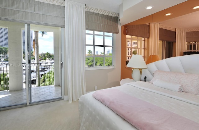 bedroom featuring access to outside, multiple windows, and carpet flooring