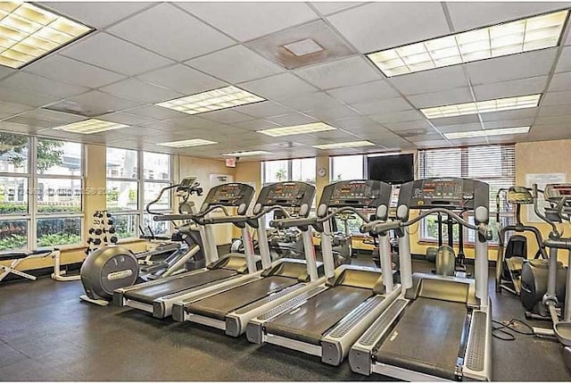 gym with a paneled ceiling