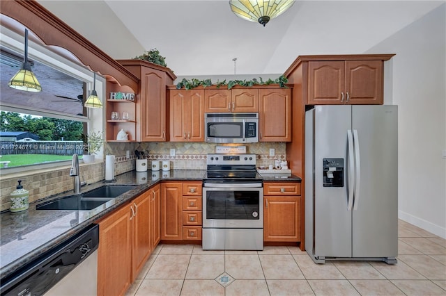 kitchen featuring stainless steel appliances, tasteful backsplash, sink, and decorative light fixtures