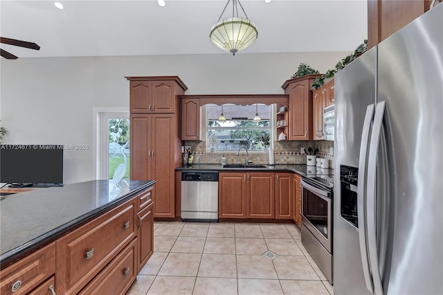 kitchen with sink, light tile patterned floors, plenty of natural light, stainless steel appliances, and backsplash