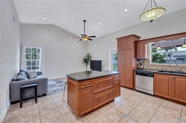 kitchen with sink, light tile patterned floors, dishwasher, backsplash, and a center island