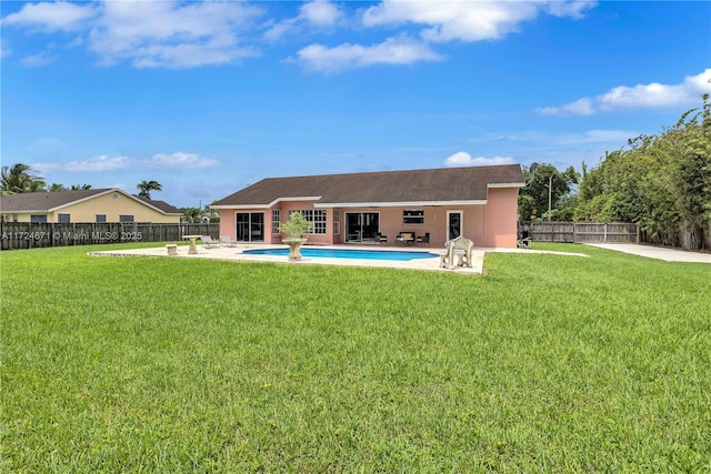 rear view of house with a patio area and a lawn