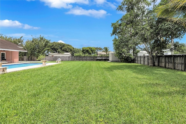 view of yard with a fenced in pool