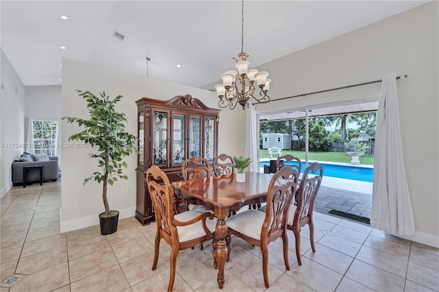 tiled dining space featuring a chandelier