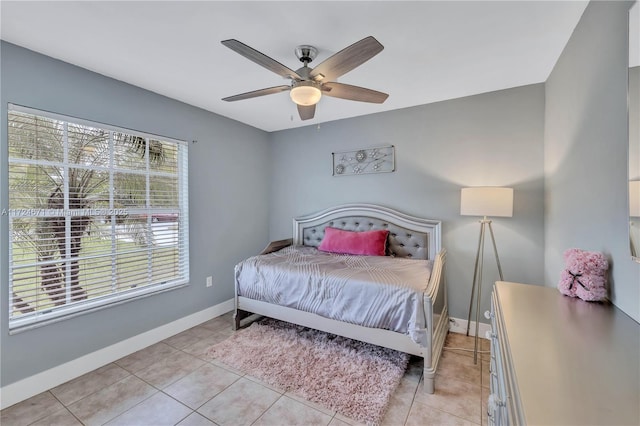 bedroom with ceiling fan and light tile patterned floors