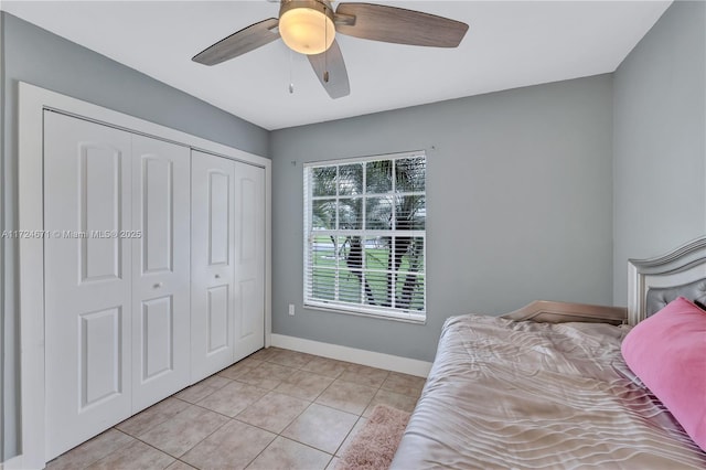 tiled bedroom featuring a closet and ceiling fan